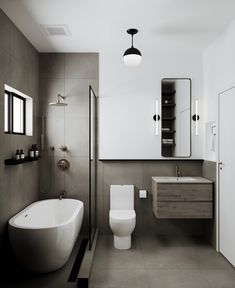 a white toilet sitting next to a bath tub under a bathroom mirror above a sink