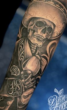 a man's arm with a skeleton holding a skull and crossbones on it