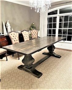 a dining room table with chairs and a chandelier