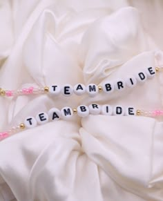 the bride and groom's name bracelets are made out of beads