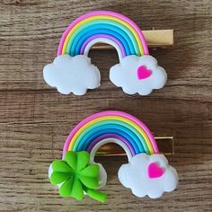 two rainbows and a cloud with a green bow are on the wooden table next to each other