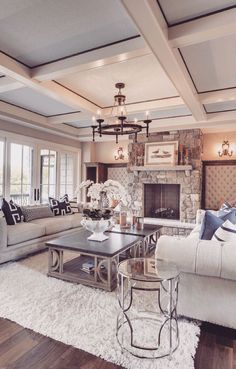 a living room filled with furniture and a fire place in the middle of a room