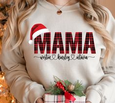 Personalized Mama Claus Christmas shirt with Kid's names, Mom gift for Christmas, mama shirt, mom shirt custom mama shirt, Personalized Mom shirt, Merry mama gift with kids names >> Runs bigger to size Ideal for any situation, a unisex heavy blend crewneck sweatshirt is pure comfort. These garments are made from polyester and cotton. This combination helps designs come out looking fresh and beautiful. The collar is ribbed knit, so it retains its shape even after washing. There are no itchy side Christmas Custom, Kids Names, Mama Gifts, Mama Sweatshirt, Gift For Christmas, Holiday Shirts, Mama Shirt, Vinyl Colors