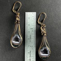 Elevate your style with our exquisite Tabasco Geode earrings, a striking blend of natural wonder and creative design by our wire wrap artist Lalańya! With their unique charm and vibrant energy, these earrings are not only a fashion statement but also a connection to the Earth's geological marvels. Geodes are known for their ability to harmonize energies and enhance spiritual connectivity. Wearing Tabasco Geodes can serve as a reminder of the Earth's magnificent creativity and resilience. The geode's crystalline interior symbolizes hidden treasures waiting to be discovered, mirroring the depths of human potential and inner beauty. These geodes are also excellent protective stones and they can be used to strengthen one's creativity! Wrapped by our exclusive artist, when properly cared for th Nickel-free Metal Fusion Jewelry, Wire Wrapped Metal Chandelier Earrings For Gift, Fusion Style Metal Drop Earrings Jewelry, Handmade Fusion Long Drop Jewelry, Artisan Metal Beaded Earrings Nickel Free, Nickel-free Artisan Metal Beaded Earrings, Wire Wrapped Metal Long Drop Jewelry, Wire Wrapped Metal Drop Earrings, Wire Wrapped Long Drop Metal Jewelry