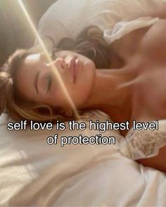 a woman laying on top of a bed next to a white pillow with the words self love is the highest level of protection