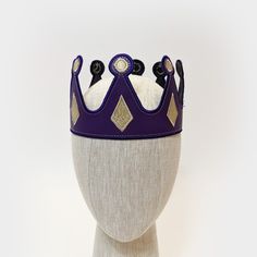 These medieval crowns are great for any royal themed event or anyone trying to finish a king, queen, prince, or princess costume. Each crown is made from vinyl leather with embroidered edges. Crowns have adjustable hook/loop fastening in the back to fit a range of sizes (one size fits most). CHOOSE FROM 15 COLOR OPTIONS PLAIN CROWNS - Solid color crowns with matching stitching along the edges for a clean finish CROWN WITH JEWELS - Choose your crown color and then we will provide an additional la Royal Teardrop Crown For Party, Royal Crown With Pinched Crown For Party, Adjustable Tall Crown For Costume, Adjustable Round Crown For Costume Party, Adjustable Crown For Cosplay, Adjustable Costume Crown, Adjustable Structured Crown For Costume, Adjustable Structured Costume Crown, Medieval Crowns