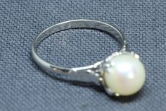 Sterling Silver Akoya Pearl Ring. Vintage Japanese Akoya Pearl ring. 8mm pearl set in solid sterling silver. Ring would make a lovely alternative engagement ring and the pearl is June's birthstone. Ring is fully hallmarked and will arrive gift boxed. * HALLMARKS Silver. * SIZE 6 1/2, ring could be resized by any good jeweler. Pearl is 8mm * WEIGHT 2.23 Grams * CONDITION In excellent condition. Please use pictures as part of item's description. * MATERIALS Sterling Silver, cultured Akoya Pearl. Elegant 925 Stamped Pearl Promise Ring, Silver Hallmarked Round Cut Pearl Ring, Silver Hallmarked Pearl Ring For Wedding, White Gold Pearl Ring Stamped 925, Silver Round Solitaire Pearl Ring, Silver Solitaire Pearl Ring, Formal Round Pearl Ring Stamped 925, Elegant White Gold Pearl Ring Stamped 925, Elegant Formal Pearl Ring Stamped 925