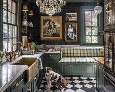 a dog sitting in the middle of a kitchen with green cabinets and checkered flooring