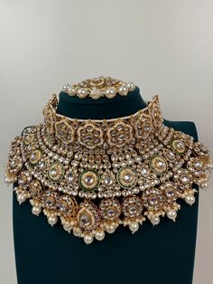 Finish: Gold plated  Necklace Fastening: Adjustable Dori Earring Fastening: Push Back  Contains: 1 necklace, 1 pair of earrings and Maang Tikka Gold Kundan Necklace, Kundan Necklace Set, Kundan Choker, Bridal Necklace Set, Necklace Indian, Maang Tikka, Indian Necklace, Kundan Necklace, Indian Wedding Jewelry