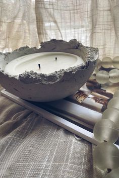 a candle is sitting in a bowl on a table