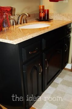 a bathroom vanity with two candles on it