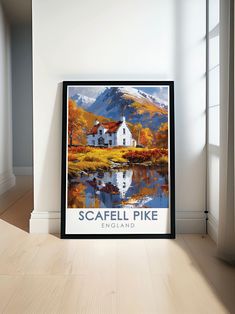 a framed poster on the wall in front of a window with a view of a lake and mountains