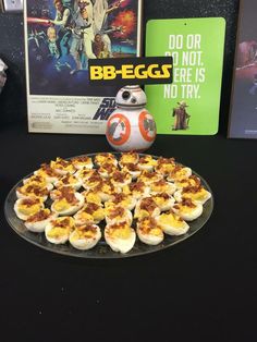 star wars themed appetizers are displayed on a table with a poster in the background