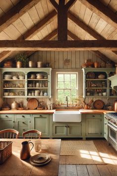 a kitchen with green cabinets and wooden floors is pictured in this image, there are many dishes on the shelves above the sink