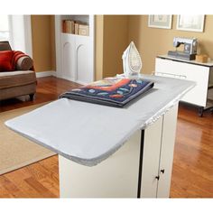 an ironing board sitting on top of a kitchen counter