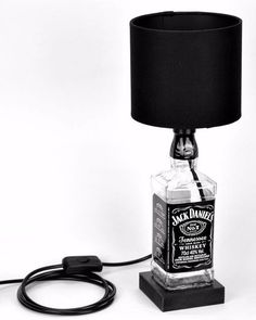 a lamp that has a bottle on top of it with a cord attached to it