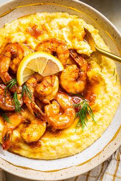 a bowl filled with shrimp and grits on top of a table