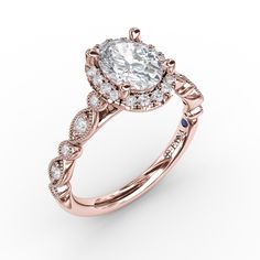 a rose gold engagement ring with an oval cut diamond center surrounded by small round diamonds