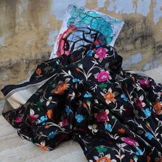 "A flower blossoms for its own joy, but this saree's splendour is entirely yours! A delightful handwoven piece with many hues and rich zari work.\u00a0\n\n\n Color\u00a0- A ravishing shade of Black\n\n Technique\u00a0-\u00a0Classic handwoven Banarasi Meenakari art passed down through generations. Meenakari involves the painstaking addition of supplementary coloured resham threads during the hand-weaving process.\n\n\n Fabric\u00a0- Soft as butter, pure Katan Silk\n\n Speciality\u00a0- A beautifully handwoven allover floral jaal with multicoloured Meenakari, creating a veritable bouquet on the yards of cloth.\u00a0\n\n Tilfi Promise\u00a0- Pure. Handloom. Banaras.\n\n\n\nSince\u00a0this product is handwoven, there might be slight irregularities. But don't you think these add to the singular Luxury Black Banarasi Silk Traditional Wear, Luxury Black Handloom Saree, Luxury Black Katan Silk Pre-draped Saree, Color Of Night, Banaras Sarees, Black Pure, Trendy Sarees, Katan Silk, Zari Work