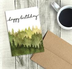 a card with the words happy birthday on it next to a cup of coffee and envelope