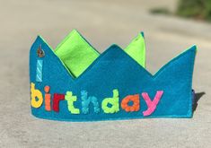 This felt birthday crown is sure to make your little one stand out with style! All shapes/flowers/embellishments are made by hand by me, making each crown one-of-a-kind! If you would like other colors or themes, just message me and I will be glad to make it to your liking! Crown is finished with stitching all the way around and fitted with elastic so it stays put on your child's head! *Letter colors may vary in order Whimsical Tall Crown For Birthday, Cute Birthday Crown With Round Shape, Felt Birthday Crown, Boys Costumes, Glitter Crown, Birthday Crown, Boy Costumes, Other Colors, Little One