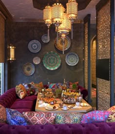 a living room filled with lots of furniture and plates on the wall