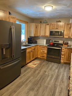 a kitchen with wooden cabinets and stainless steel appliances