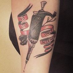 a tattoo with scissors and ribbons on it