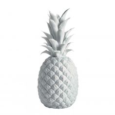 a white pineapple shaped vase sitting on top of a table