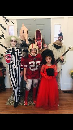 three children in costumes posing for a photo