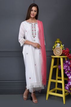 White straight long kurta with hand embroidered floral motif thread work, bullion knots, fringe hem and lace trim detail. Comes with pants and contrast chiffon dupatta.
Component: 3
Embroidered
Neckine: Round
Sleeve Length: Three Quarter
Fabric: Kurta and Pant: Silk Chanderi; Dupatta: Chiffon
Color: White
Side slits
Fringe detail
Lace hem - Aza Fashions White Floral Embroidered Dupatta For Navratri, White Palazzo Set With Embroidered Border And Straight Kurta, White Sharara With Embroidered Border And Straight Kurta, White Embroidered Palazzo Set For Diwali, White Palazzo Set With Embroidered Border For Festivals, White Embroidered Palazzo Set For Eid, Festive White Palazzo Set With Embroidered Border, White Floral Embroidered Dupatta For Diwali, Festival White Palazzo Set With Embroidered Border