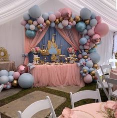 a pink and blue dessert table with lots of balloons in the shape of princess castle