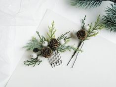 Winter hair accessories with pine cones, faux greenery and berries is perfect hair accessories for a wedding, birthday party or a photo shoot * Size on foto * Amazing details. These flowers look so incredibly realistic. They are very soft and light weight. The perfect hair piece for your special day!  ♥ Take a peek at other accessories with flowers in my shop! :) https://www.etsy.com/shop/FloralAccessoriesUA ♥ Please keep in mind that real colors may slightly differ because it depends on each monitor settings. ♥ You can look at the FAQs: * Looking for multiples? * Custom orders * Care instructions * If you don't have PayPal account Christmas Wedding Hair Pieces, Pine Needle Hair Accessories, Winter Wedding Bouquet With Pinecones, Christmas Bridal Hairpiece, Fern Bridal Hair Piece, Evergreen Hair Piece, Evergreen Wedding, Autumn Hair Accessories, Bride Hair Piece