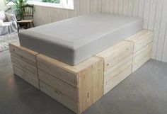 a bed that is made out of wood and has no sheets on the bottom layer