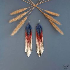 two pairs of beaded earrings with red, white and blue beads hanging from them