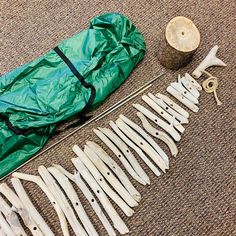 the tools are laid out on the floor next to an umbrella and some wood shavings