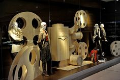 a display case filled with mannequins and movie reels