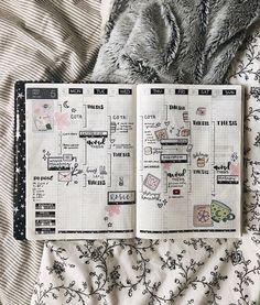 an open planner sitting on top of a bed