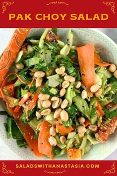 a salad with carrots, lettuce and chickpeas is in a bowl