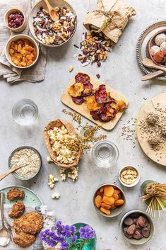 a table topped with bowls and plates filled with food