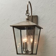 an outdoor wall light with three lights on it