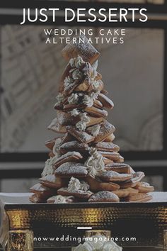 a stack of doughnuts sitting on top of a table with the words just desserts wedding cake alternatives