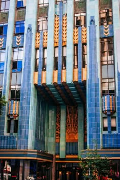 an art deco building with blue tiles and gold accents