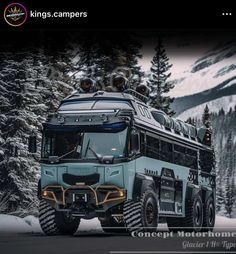 a large truck driving down a road next to snow covered trees and evergreens in the background