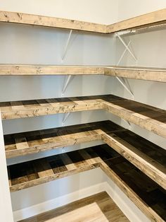 an empty room with shelves made out of wood