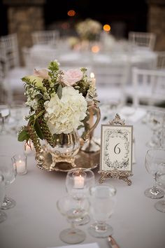 the table is set with white flowers and candles