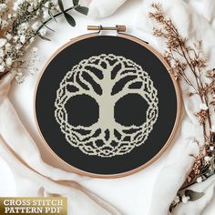 a cross stitch pattern with a tree on it