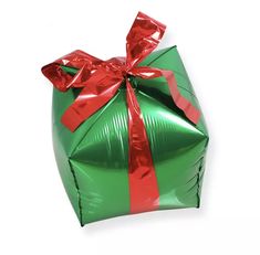 a green wrapped gift box with red ribbon on it's top and bow at the end