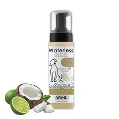 a bottle of waterless dog shampoo next to a cut in half coconut and lime