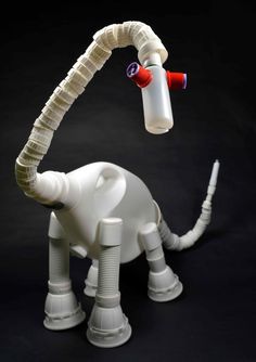 an elephant made out of plastic bottles and pipe tubes with a tube attached to it